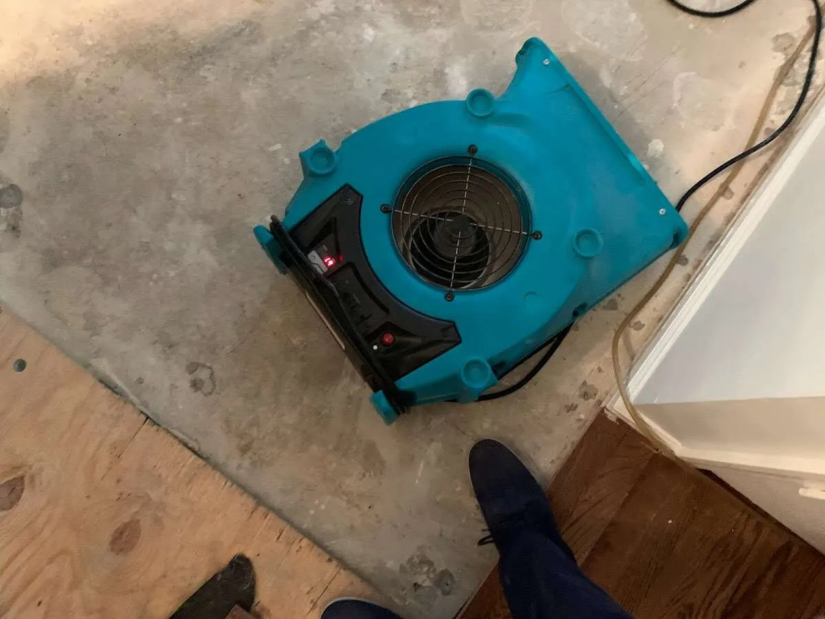 Air mover drying subfloor during Commercial Water Damage Restoration in Tequesta